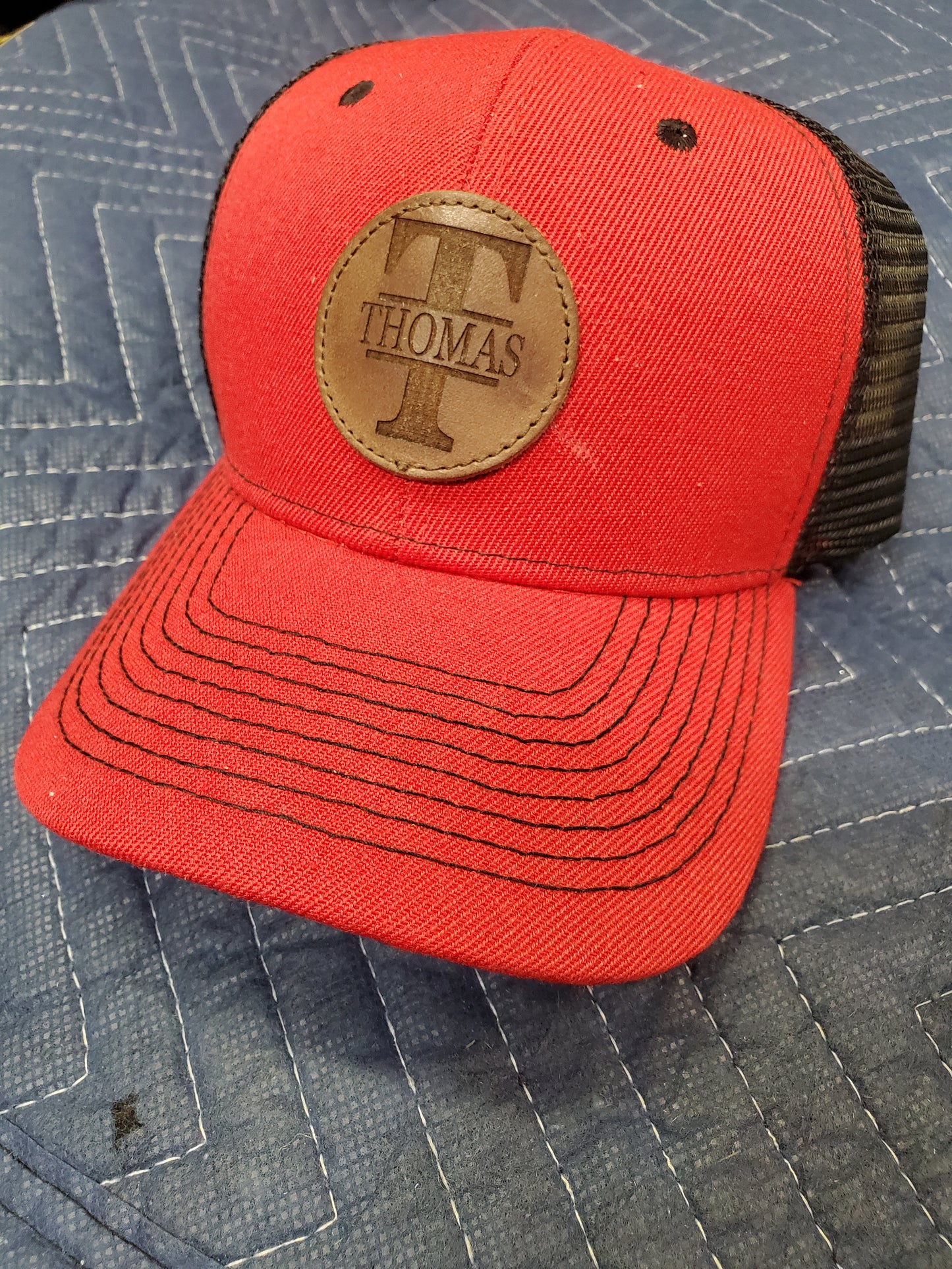 Red Trucker Hat with Laser Engraved Round Mocha Leather Patch